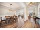 Open-concept dining area featuring hardwood floors, wainscoting, and modern lighting at 115 Bluff Isle Ct, Summerville, SC 29486