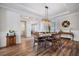 Dining room boasts tray ceiling, modern lighting, and wood floors at 115 Bluff Isle Ct, Summerville, SC 29486