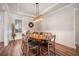 Dining room features a modern light fixture, wood floors, and wainscoting at 115 Bluff Isle Ct, Summerville, SC 29486