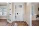 Bright entryway with hardwood floors, white trim, and stylish front door at 115 Bluff Isle Ct, Summerville, SC 29486