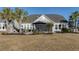 Beautiful home exterior with a spacious patio, manicured lawn, and lush landscaping at 115 Bluff Isle Ct, Summerville, SC 29486