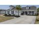 Charming home with manicured lawn, mature palm tree, and spacious driveway at 115 Bluff Isle Ct, Summerville, SC 29486
