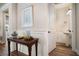 Hallway leading to a powder room, decorated with a table and framed art at 115 Bluff Isle Ct, Summerville, SC 29486