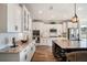 Bright kitchen featuring white cabinets, granite countertops, stainless steel appliances, and a center island with wine rack at 115 Bluff Isle Ct, Summerville, SC 29486