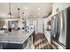 Bright kitchen with a large island, stainless appliances, granite counters, and views into other living spaces through doorways at 115 Bluff Isle Ct, Summerville, SC 29486