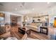 Bright, open-concept living room with hardwood floors, a modern ceiling fan, and views into the kitchen and dining area at 115 Bluff Isle Ct, Summerville, SC 29486