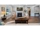 Inviting living room featuring a fireplace with elegant mantle, comfortable seating, and a large window for natural light at 115 Bluff Isle Ct, Summerville, SC 29486