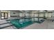 An indoor swimming pool with lounge seating and natural light for year-round enjoyment at 115 Bluff Isle Ct, Summerville, SC 29486