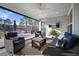 Screened-in porch features comfortable seating, views of palm trees, and a scenic pond with a fountain at 115 Bluff Isle Ct, Summerville, SC 29486
