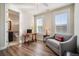 Bright sitting area features hardwood floors, natural light, and an adjacent bathroom with tile flooring and a dark vanity at 115 Bluff Isle Ct, Summerville, SC 29486