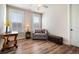 A cozy sitting room with hardwood floors, a grey chair, and a leather bench at 115 Bluff Isle Ct, Summerville, SC 29486