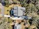 Aerial view of a two-story home with a large driveway and lush landscaping at 129 Sparrow Dr, Isle of Palms, SC 29451