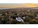 Aerial view of a two-story home surrounded by mature trees near a beautiful oceanfront at 129 Sparrow Dr, Isle of Palms, SC 29451