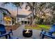 Inviting backyard with a cozy fire pit surrounded by Adirondack chairs and a picturesque view of the home at 129 Sparrow Dr, Isle of Palms, SC 29451