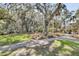 A lush, green backyard featuring mature shade trees at 129 Sparrow Dr, Isle of Palms, SC 29451