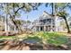 Spacious backyard showcasing multiple elevated homes and verdant green grass at 129 Sparrow Dr, Isle of Palms, SC 29451