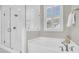 Modern bathroom featuring a glass-enclosed shower, soaking tub, and stylish fixtures at 129 Sparrow Dr, Isle of Palms, SC 29451