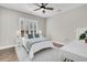 Cozy bedroom with a queen bed, blue and white accents, ceiling fan, and wood flooring at 129 Sparrow Dr, Isle of Palms, SC 29451