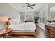 Comfortable bedroom with bright windows, hardwood floors, and dark wood furnishings at 129 Sparrow Dr, Isle of Palms, SC 29451