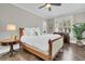 Cozy bedroom featuring a classic wood frame bed and views from shuttered windows at 129 Sparrow Dr, Isle of Palms, SC 29451