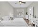 Stylish bedroom featuring a queen bed, white linens, wood floors, and view of the outdoors at 129 Sparrow Dr, Isle of Palms, SC 29451