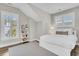 Comfortable bedroom with a queen bed, sloped ceiling, wood floors, and bright windows at 129 Sparrow Dr, Isle of Palms, SC 29451