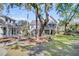 Beautiful two-story home with a manicured lawn and mature trees, creating a picturesque setting at 129 Sparrow Dr, Isle of Palms, SC 29451