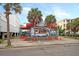 Charming exterior view of colorful Joey To Go shop with red trim and two palm trees at 129 Sparrow Dr, Isle of Palms, SC 29451