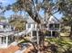 Aerial view of a home with a large tree, and a well-maintained yard and deck at 129 Sparrow Dr, Isle of Palms, SC 29451