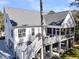 Rear exterior featuring a screened in porch, deck, and outdoor grill at 129 Sparrow Dr, Isle of Palms, SC 29451