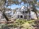 Elevated home with lush green grass and screened in porch at 129 Sparrow Dr, Isle of Palms, SC 29451
