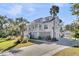 Beautiful home exterior with landscaped yard and detached garage at 129 Sparrow Dr, Isle of Palms, SC 29451
