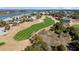 Aerial view of a meticulously manicured golf course with lush green fairways and scenic water features surrounded by waterfront homes at 129 Sparrow Dr, Isle of Palms, SC 29451
