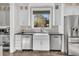 Modern kitchen with stainless steel appliances, white cabinets, and a large farmhouse sink at 129 Sparrow Dr, Isle of Palms, SC 29451