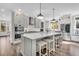 Modern kitchen with a large island, stainless steel appliances, and counter seating at 129 Sparrow Dr, Isle of Palms, SC 29451