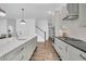 Open kitchen featuring a large center island, stainless steel appliances, and hardwood flooring at 129 Sparrow Dr, Isle of Palms, SC 29451