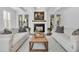 Sophisticated living room with a modern fireplace, neutral decor, and comfortable seating arrangement at 129 Sparrow Dr, Isle of Palms, SC 29451