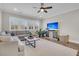 Comfortable living room with a large sectional sofa, ceiling fan, and media center with a flat screen TV at 129 Sparrow Dr, Isle of Palms, SC 29451