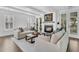 Bright living room with fireplace, white shiplap walls, and coffered ceilings at 129 Sparrow Dr, Isle of Palms, SC 29451