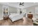 Serene main bedroom with large windows, hardwood flooring, and ensuite office space at 129 Sparrow Dr, Isle of Palms, SC 29451