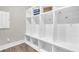 Bright mudroom with custom white storage lockers, hooks, and a bench to keep things organized at 129 Sparrow Dr, Isle of Palms, SC 29451