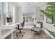 Bright and airy office space featuring a modern desk, comfortable seating, and shuttered windows at 129 Sparrow Dr, Isle of Palms, SC 29451