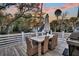 Outdoor dining area with a wooden table, wicker chairs, grill and scenic views, ideal for entertaining at 129 Sparrow Dr, Isle of Palms, SC 29451
