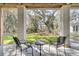 Relaxing outdoor space with two chairs and a small table with a view of the professionally landscaped yard at 129 Sparrow Dr, Isle of Palms, SC 29451