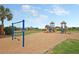 Fun playground area with swings, slides and a picnic area surrounded by palm trees and green spaces at 129 Sparrow Dr, Isle of Palms, SC 29451