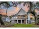 Spacious home featuring a screened porch, outdoor living space, and beautifully maintained backyard at 129 Sparrow Dr, Isle of Palms, SC 29451