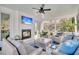 Cozy screened porch with a fireplace, TV, and comfortable seating for relaxation at 129 Sparrow Dr, Isle of Palms, SC 29451