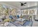 Inviting screened porch with comfortable seating, ceiling fan, and serene outdoor views at 129 Sparrow Dr, Isle of Palms, SC 29451
