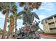 Turtle sculpture with patriotic decorations set against a backdrop of palm trees and blue sky at 129 Sparrow Dr, Isle of Palms, SC 29451