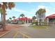 Exterior view of a charming shopping center, complete with palm trees, shaded seating, and ample parking at 129 Sparrow Dr, Isle of Palms, SC 29451